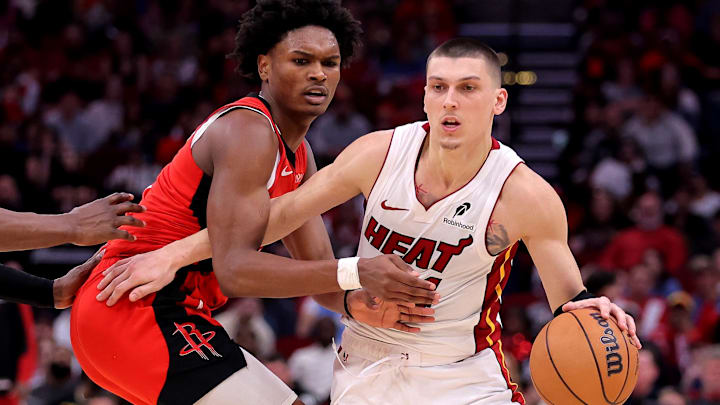 Dec 29, 2024; Houston, Texas, USA; Miami Heat guard Tyler Herro (14) handles the ball against Houston Rockets guard Amen Thompson (1) during the fourth quarter at Toyota Center. Mandatory Credit: Erik Williams-Imagn Images
