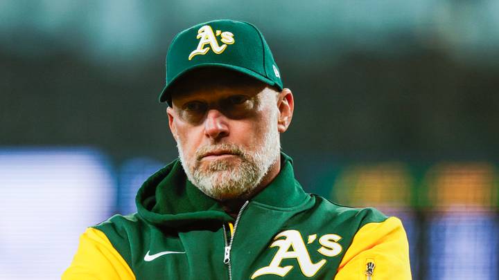 Apr 22, 2026; Seattle, Washington, USA; Athletics manager Mark Kotsay (7) talks with staff in the dugout following a batted ball that was trapped in the jersey of Seattle Mariners starting pitcher Logan Gilbert (36, not pictured) during the first inning at T-Mobile Park. The play was ruled a hit. Mandatory Credit: Joe Nicholson-Imagn Images Apr 22, 2026; Seattle, Washington, USA; Athletics manager Mark Kotsay (7) talks with staff in the dugout following a batted ball that was trapped in the jersey of Seattle Mariners starting pitcher Logan Gilbert (36, not pictured) during the first inning at T-Mobile Park. The play was ruled a hit. Mandatory Credit: Joe Nicholson-Imagn Images