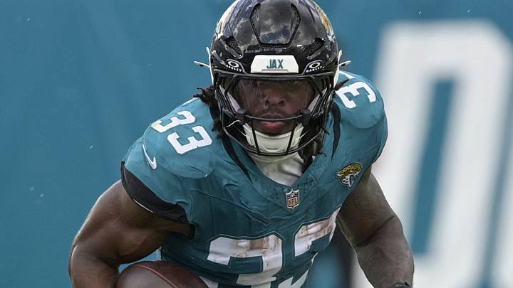 Sep 13, 2026; Jacksonville, Florida, USA;  Jacksonville Jaguars running back Bhayshul Tuten (33) runs the ball against Cleveland Browns cornerback Myles Harden (26) in the third quarter at EverBank Stadium.  Mandatory Credit: Melina Myers-Imagn Images