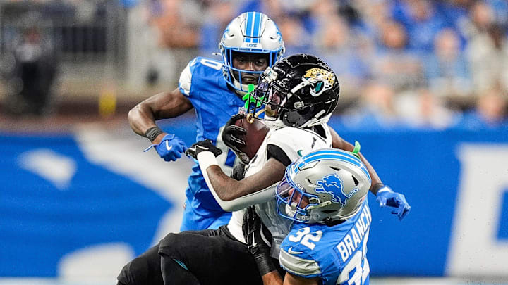 Detroit Lions safety Brian Branch (32) tackles Jacksonville Jaguars running back Travis Etienne Jr. (1)during the second half at Ford Field in Detroit on Sunday, Nov. 17, 2024.