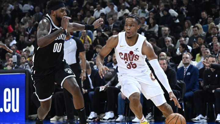 Jan 11, 2024; Paris, FRANCE; Cleveland Cavaliers forward Isaac Okoro (35) is defended by Brooklyn Nets forward Royce O'Neale (00) in the NBA Paris Game at AccorHotels Arena. Mandatory Credit:  Alexis Reau/Presse Sports via USA TODAY Sports