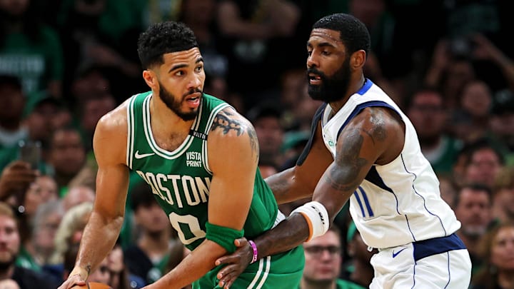 Jun 17, 2024; Boston, Massachusetts, USA; Boston Celtics forward Jayson Tatum (0) handles the ball against Dallas Mavericks guard Kyrie Irving (11) in game five of the 2024 NBA Finals at TD Garden. Mandatory Credit: Peter Casey-Imagn Images