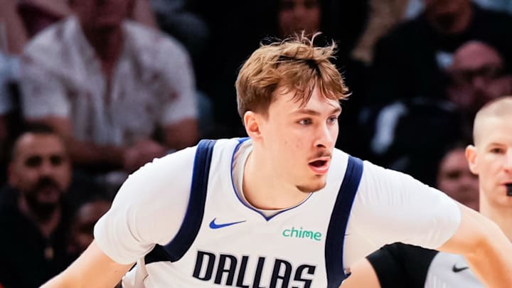 Dallas Mavericks forward Cooper Flagg goes against Phoenix Suns guard Devin Booker.