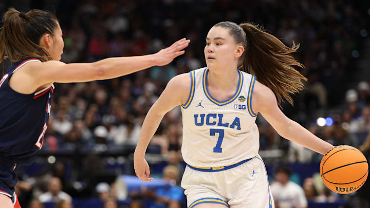 Apr 4, 2025; Tampa, FL, USA; UCLA Bruins guard Elina Aarnisalo (7) dribbles against Connecticut Huskies guard Kaitlyn Chen (20) during first quarter in a semifinal of the women's 2025 NCAA tournament at Amalie Arena. Mandatory Credit: Nathan Ray Seebeck-Imagn Images Apr 4, 2025; Tampa, FL, USA; UCLA Bruins guard Elina Aarnisalo (7) dribbles against Connecticut Huskies guard Kaitlyn Chen (20) during first quarter in a semifinal of the women's 2025 NCAA tournament at Amalie Arena. Mandatory Credit: Nathan Ray Seebeck-Imagn Images
