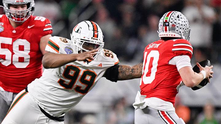 Dec 31, 2025; Arlington, TX, USA; Miami Hurricanes defensive line Ahmad Moten Sr. (99) attempts to sack Ohio State Buckeyes quarterback Julian Sayin (10) in the second quarter during the 2025 Cotton Bowl and quarterfinal game of the College Football Playoff at AT&T Stadium. Mandatory Credit: Jerome Miron-Imagn Images