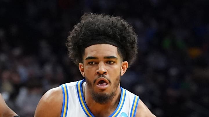 Mar 20, 2026; Philadelphia, PA, USA; UCLA Bruins guard Eric Freeny (8) dribbles the ball against UCF Knights forward Jamichael Stillwell (4) in the first half during a first round game of the men's 2026 NCAA Tournament at Xfinity Mobile Arena. Mandatory Credit: Kyle Ross-Imagn Images