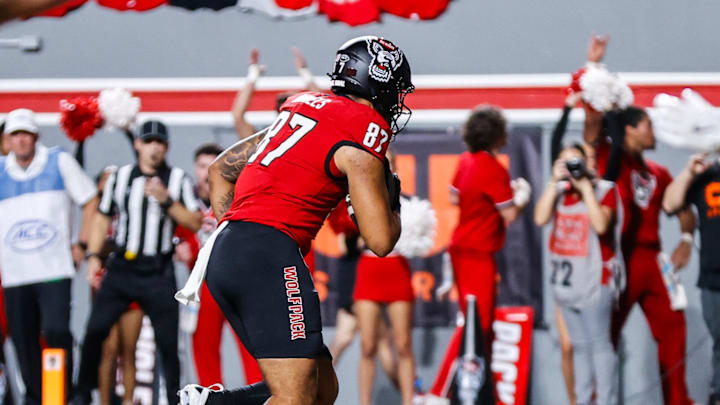 Sep 27, 2025; Raleigh, North Carolina, USA;  North Carolina State Wolfpack tight end Dante Daniels (87) makes a touchdown during the first half of the game against Virginia Tech Hokies at Carter-Finley Stadium. Mandatory Credit: Jaylynn Nash-Imagn Images