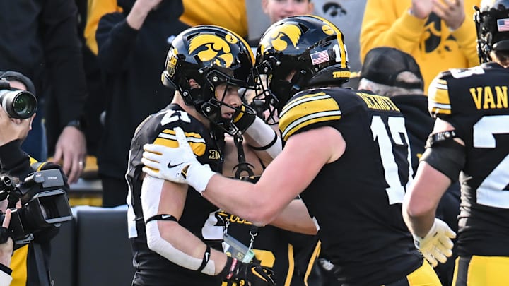 Nov 22, 2025; Iowa City, Iowa, USA; Iowa Hawkeyes wide receiver Kaden Wetjen (21) reacts with wide receiver Alex Eichmann (17) and teammates after scoring a touchdown on a punt return against the Michigan State Spartans during the second quarter at Kinnick Stadium. Mandatory Credit: Jeffrey Becker-Imagn Images