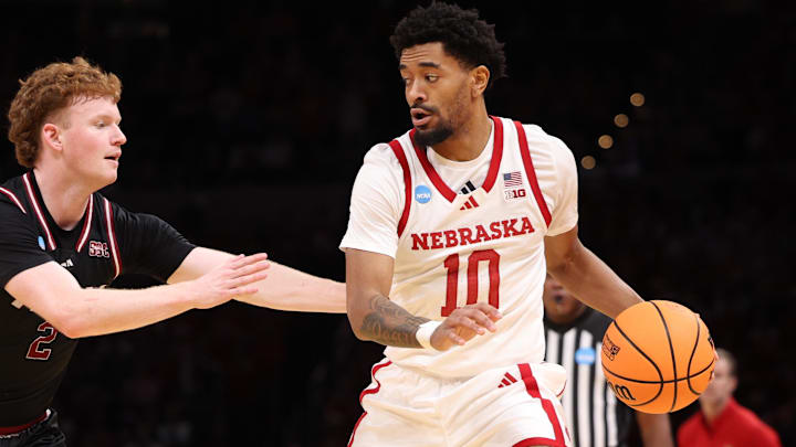 Jamarques Lawrence drives past Troy guard Cobi Campbell during the first half.