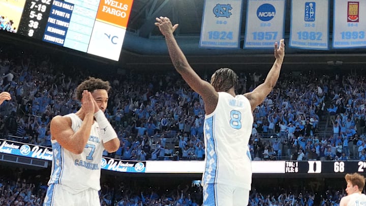 Feb 7, 2026; Chapel Hill, North Carolina, USA; North Carolina Tar Heels guard Seth Trimble (7) and forward Caleb Wilson (8) and teammates celebrate after Trimble hits a three point shot with .04 left to go in the second half at Dean E. Smith Center. Mandatory Credit: Bob Donnan-Imagn Images