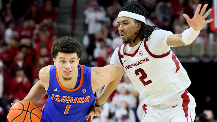 Jan 11, 2025; Fayetteville, Arkansas, USA; Florida Gators guard Walter Clayton Jr. (1) drives against Arkansas Razorbacks guard Boogie Fland (2) during the second half at Bud Walton Arena. Florida won 71-63. Mandatory Credit: Nelson Chenault-Imagn Images