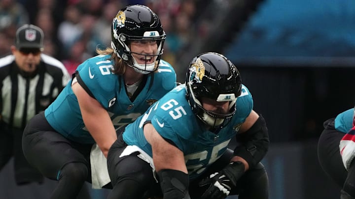 Oct 20, 2024; London, United Kingdom; Jacksonville Jaguars quarterback Trevor Lawrence (16) prepares to take the snap from center Mitch Morse (65) against the New England Patriots in the second half of an NFL International Series game at Wembley Stadium. Mandatory Credit: Kirby Lee-Imagn Images