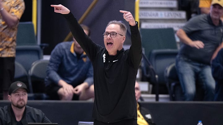 Dec 1, 2024; Estero, FL, USA; West Virginia University head coach Mark Kellogg calls a play in the from the sidelines in the fourth quarter during the Women's Gulf Coast Showcase at Hertz Arena. Mandatory Credit: Chris Tilley-Imagn Images