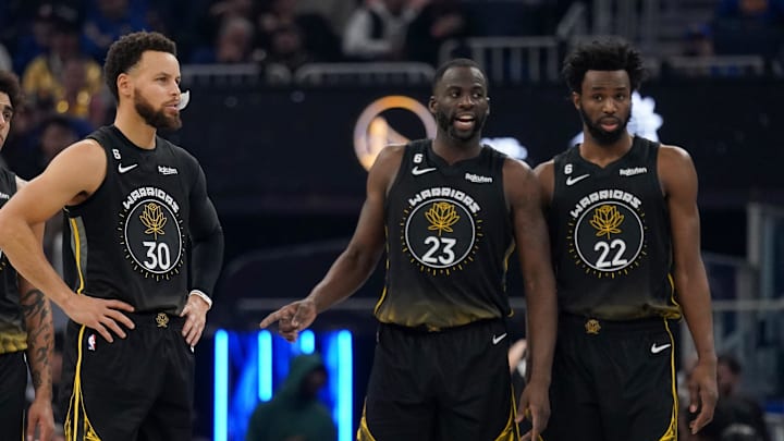 Jan 10, 2023; San Francisco, California, USA; Golden State Warriors guard Stephen Curry (30) stands on the court next to forward Anthony Lamb (40), forward Draymond Green (23) and forward Andrew Wiggins (22) against the Phoenix Suns in the second quarter at the Chase Center. Mandatory Credit: Cary Edmondson-USA TODAY Sports Jan 10, 2023; San Francisco, California, USA; Golden State Warriors guard Stephen Curry (30) stands on the court next to forward Anthony Lamb (40), forward Draymond Green (23) and forward Andrew Wiggins (22) against the Phoenix Suns in the second quarter at the Chase Center. Mandatory Credit: Cary Edmondson-USA TODAY Sports