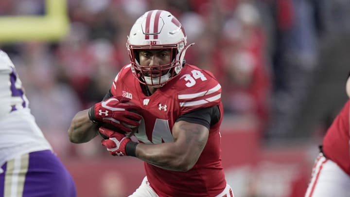 Wisconsin running back Jackson Acker (34) finds a seam in the Washington defense during the first quarter of their game Saturday, November 8, 2025 at Camp Randall Stadium in Madison, Wisconsin.