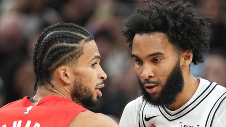 San Antonio Spurs forward Julian Champagnie gets pushed by Portland Trail Blazers guard forward Toumani Camara.
