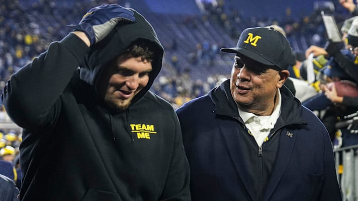 Michigan athletic director Warde Manuel talks to former Wolverines player