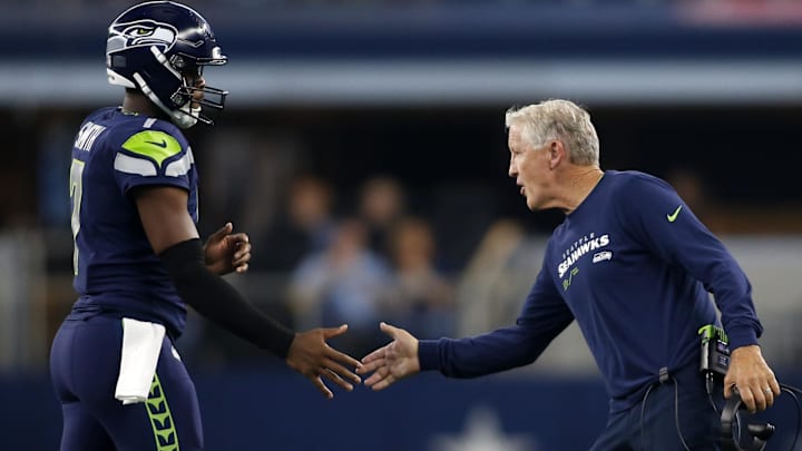 Aug 26, 2022; Arlington, Texas, USA; Seattle Seahawks head coach Pete Carroll (right) congratulates quarterback Geno Smith (7) as he comes off  the field in the first quarter against the Dallas Cowboys at AT&T Stadium. Mandatory Credit: Tim Heitman-Imagn Images