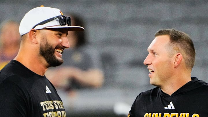 Sep 13, 2025; Tempe, Arizona, USA; Texas State Bobcats head coach G. J. Kinne and Arizona State Sun Devils head coach Kenny Dillingham speak before the game between Arizona State Sun Devils and Texas State Bobcats. Mandatory Credit: Arianna Grainey-Imagn Images Sep 13, 2025; Tempe, Arizona, USA; Texas State Bobcats head coach G. J. Kinne and Arizona State Sun Devils head coach Kenny Dillingham speak before the game between Arizona State Sun Devils and Texas State Bobcats. Mandatory Credit: Arianna Grainey-Imagn Images