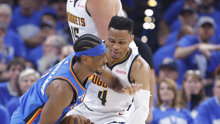 May 18, 2025; Oklahoma City, Oklahoma, USA; Oklahoma City Thunder guard Shai Gilgeous-Alexander (2) is fouled by Denver Nuggets guard Russell Westbrook (4) on a drive in the second quarter during game seven of the second round for the 2025 NBA Playoffs at Paycom Center. Mandatory Credit: Alonzo Adams-Imagn Images