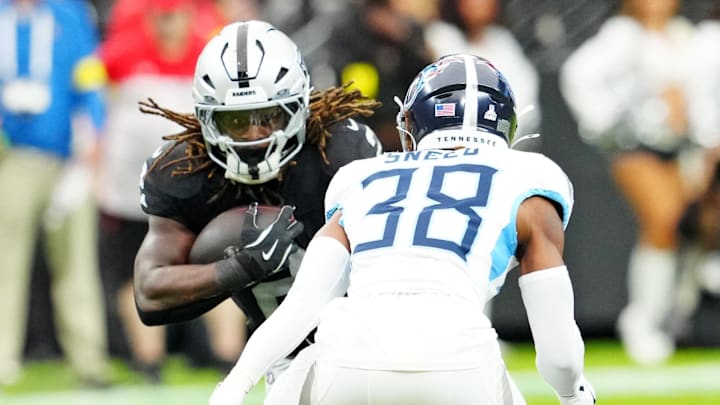 Oct 12, 2025; Paradise, Nevada, USA; Las Vegas Raiders running back Ashton Jeanty (2) runs the ball against Tennessee Titans cornerback L'Jarius Sneed (38) during the first half at Allegiant Stadium. Mandatory Credit: Stephen R. Sylvanie-Imagn Images Oct 12, 2025; Paradise, Nevada, USA; Las Vegas Raiders running back Ashton Jeanty (2) runs the ball against Tennessee Titans cornerback L'Jarius Sneed (38) during the first half at Allegiant Stadium. Mandatory Credit: Stephen R. Sylvanie-Imagn Images