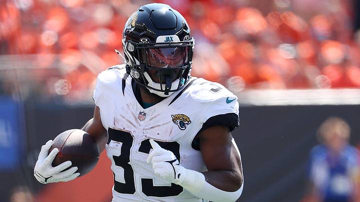 Sep 14, 2025; Cincinnati, Ohio, USA;  Jacksonville Jaguars running back Bhayshul Tuten (33) runs the ball during the first quarter against the Cincinnati Bengals at Paycor Stadium. Mandatory Credit: Joseph Maiorana-Imagn Images