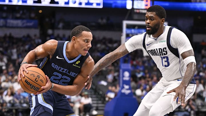 Oct 7, 2024; Dallas, Texas, USA; Memphis Grizzlies guard Desmond Bane (22) looks to move the ball past Dallas Mavericks forward Naji Marshall (13) during the second half at the American Airlines Center. Mandatory Credit: Jerome Miron-Imagn Images