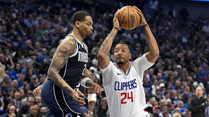 Apr 26, 2024; Dallas, Texas, USA; LA Clippers guard Norman Powell (24) drives to the basket past Dallas Mavericks forward P.J. Washington (25) during the second quarter during game three of the first round for the 2024 NBA playoffs at the American Airlines Center. Mandatory Credit: Jerome Miron-Imagn Images