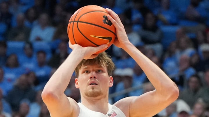 Feb 23, 2026; Chapel Hill, North Carolina, USA; North Carolina Tar Heels center Henri Veesaar (13) shoots a three point shot as Louisville Cardinals forward Vangelis Zougris (53) defends in the second half at Dean E. Smith Center. Mandatory Credit: Bob Donnan-Imagn Images