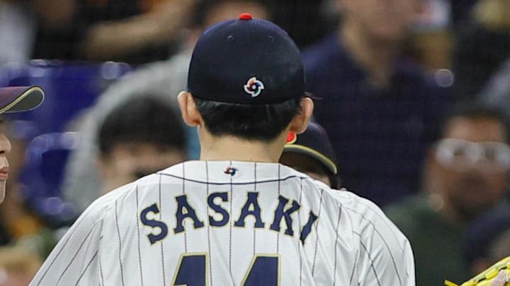 Mar 20, 2023; Miami, Florida, USA; Japan starting pitcher Roki Sasaki (14) celebrates with teammates after the first inning against Mexico at LoanDepot Park Mar 20, 2023; Miami, Florida, USA; Japan starting pitcher Roki Sasaki (14) celebrates with teammates after the first inning against Mexico at LoanDepot Park