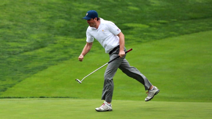 Keegan Bradley celebrates a birdie putt during  the 2013 Presidents Cup at Muirfield Village Golf Club.