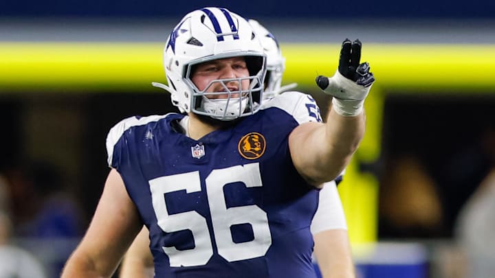 Nov 28, 2024; Arlington, Texas, USA; Dallas Cowboys center Cooper Beebe (56) signals at the line against the New York Giants during the second quarter at AT&T Stadium.