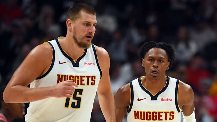 Oct 14, 2025; Denver, Colorado, USA; Denver Nuggets forward Peyton Watson (8) after scoring on an assist by center Nikola Jokic (15) during the first half at Ball Arena.