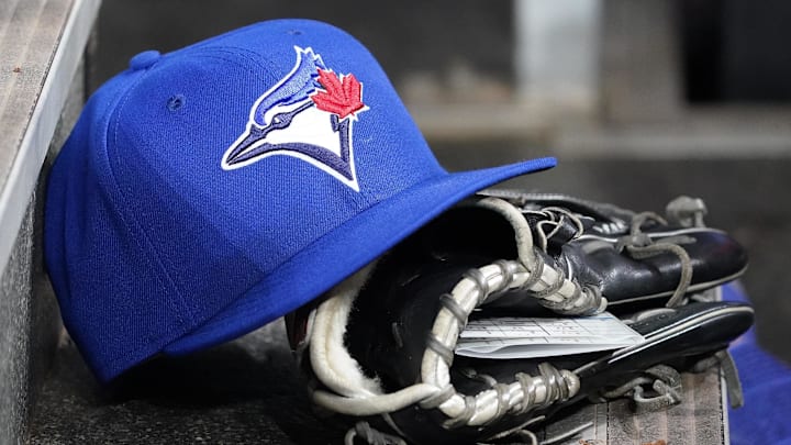 Apr 16, 2025; Toronto, Ontario, CAN; A Toronto Blue Jays hat and glove in the dugout during a game against the Atlanta Braves at Rogers Centre. 