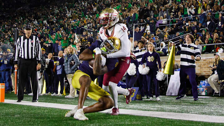 Notre Dame wide receiver Deion Colzie (0) catches a pass in the end zone for a touchdown with Florida State defensive back Cai Bates (14) defending during a NCAA college football game at Notre Dame Stadium on Saturday, Nov. 9, 2024, in South Bend. Notre Dame wide receiver Deion Colzie (0) catches a pass in the end zone for a touchdown with Florida State defensive back Cai Bates (14) defending during a NCAA college football game at Notre Dame Stadium on Saturday, Nov. 9, 2024, in South Bend.