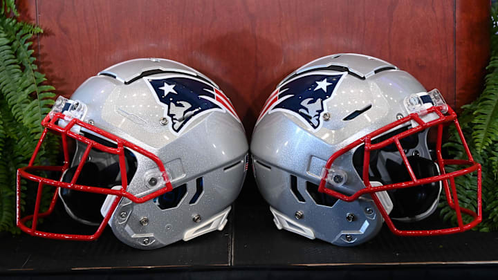 Jan 13, 2025; Foxborough, MA, USA; A pair of New England Patriots helmets sit in front of the podium before a press conference at Gillette Stadium. Mandatory Credit: Eric Canha-Imagn Images Jan 13, 2025; Foxborough, MA, USA; A pair of New England Patriots helmets sit in front of the podium before a press conference at Gillette Stadium. Mandatory Credit: Eric Canha-Imagn Images