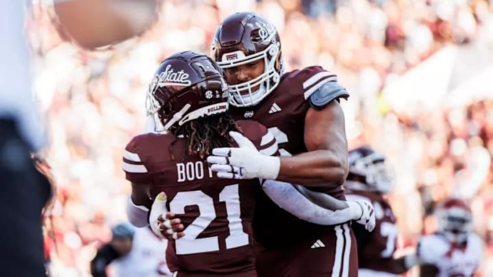 Mississippi State Running Back Davon Booth (#21) and Mississippi State Offensive Lineman Albert Reese IV (#76) during the game between the Arkansas Razorbacks and the Mississippi State Bulldogs at Davis Wade Stadium at Scott Field in Starkville, MS.
