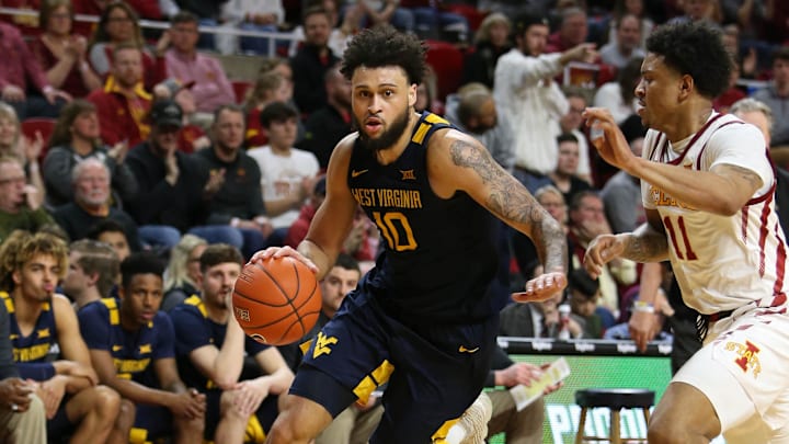 Mar 3, 2020; Ames, Iowa, USA; West Virginia Mountaineers guard Jermaine Haley (10) drives past Iowa State Cyclones guard Prentiss Nixon (11) at Hilton Coliseum. West Virginia beat Iowa State 77 to 71. 