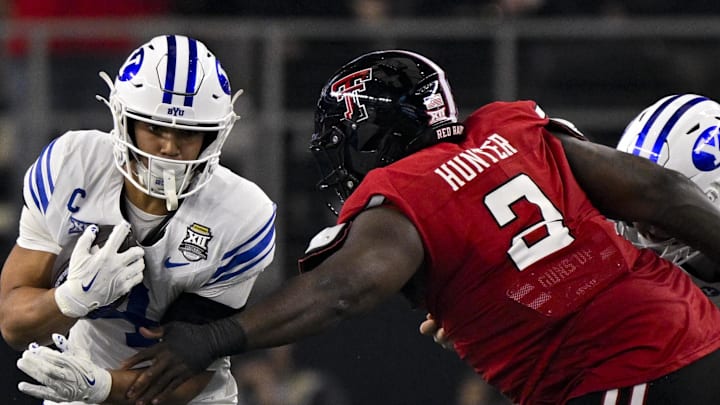 Dec 6, 2025; Arlington, TX, USA; Texas Tech Red Raiders defensive lineman Lee Hunter (2) tackles BYU Cougars running back LJ Martin (4) during the game between the Red Raiders and the Cougars at AT&T Stadium. 