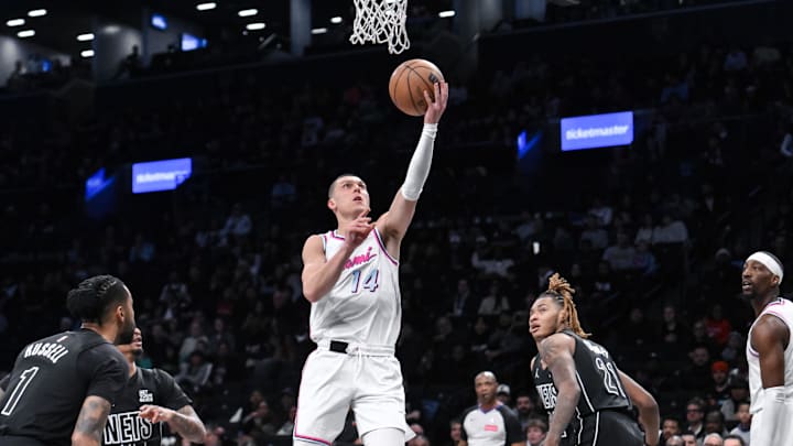 Jan 25, 2025; Brooklyn, New York, USA; Miami Heat guard Tyler Herro (14) drives to the basket while being defended by Brooklyn Nets guard Keon Johnson (45) during the first half at Barclays Center. Mandatory Credit: John Jones-Imagn Images