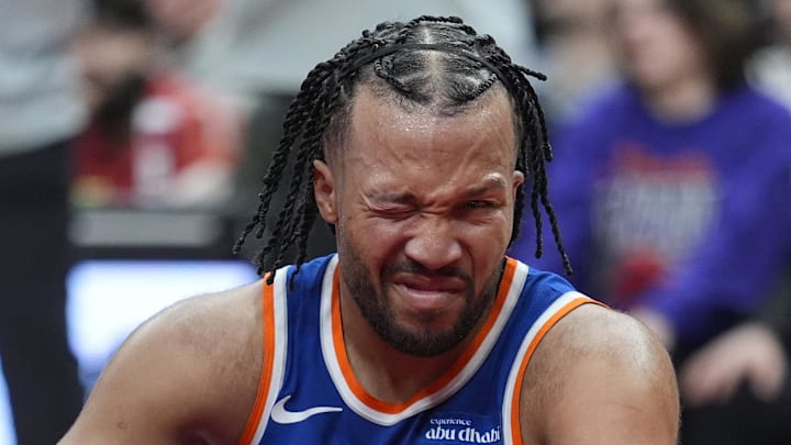 New York Knicks guard Jalen Brunson reacts after getting poked in the eye during a collision.