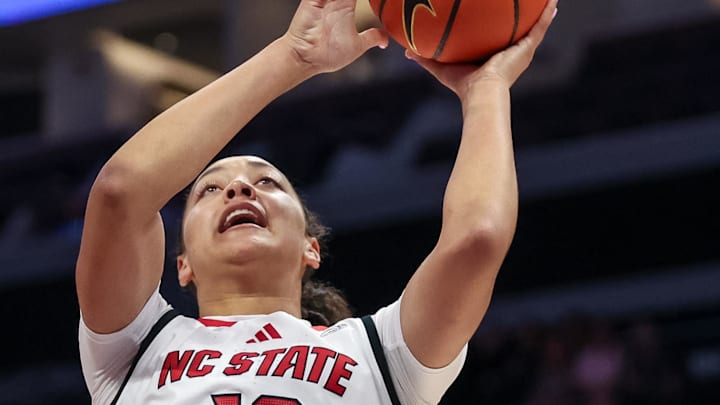 Nov 9, 2025; Charlotte, North Carolina, USA; NC State Wolfpack forward Khamil Pierre (12) shoots for the basket over Southern California Trojans forward Vivian Iwuchukwu (0) during the first quarter of the Ally Tipoff game at Spectrum Center. Mandatory Credit: Cory Knowlton-Imagn Images Nov 9, 2025; Charlotte, North Carolina, USA; NC State Wolfpack forward Khamil Pierre (12) shoots for the basket over Southern California Trojans forward Vivian Iwuchukwu (0) during the first quarter of the Ally Tipoff game at Spectrum Center. Mandatory Credit: Cory Knowlton-Imagn Images