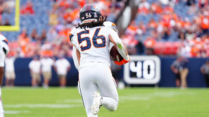 Aug 25, 2024; Denver, Colorado, USA; Denver Broncos linebacker Levelle Bailey (56) returns an interception for six points in the fourth quarter against the Arizona Cardinals at Empower Field at Mile High. 