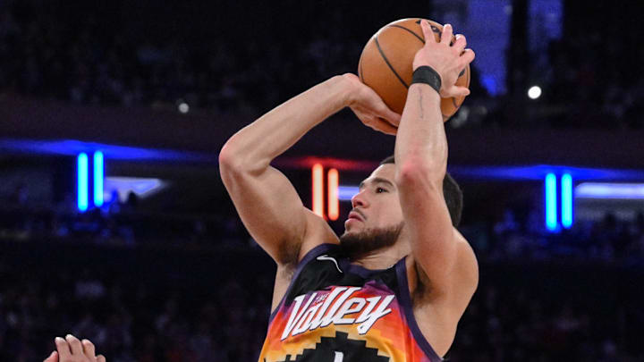 Jan 17, 2026; New York, New York, USA; Phoenix Suns guard Devin Booker (1) shoots the ball while defended by New York Knicks guard Miles McBride (2) during the second half at Madison Square Garden. Mandatory Credit: John Jones-Imagn Images