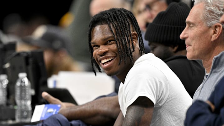 Jan 22, 2025; Dallas, Texas, USA; 2024 Heisman Trophy winner Travis Hunter Jr. laughs during the second half of the game between the Dallas Mavericks and the Minnesota Timberwolves at the American Airlines Center. Mandatory Credit: Jerome Miron-Imagn Images