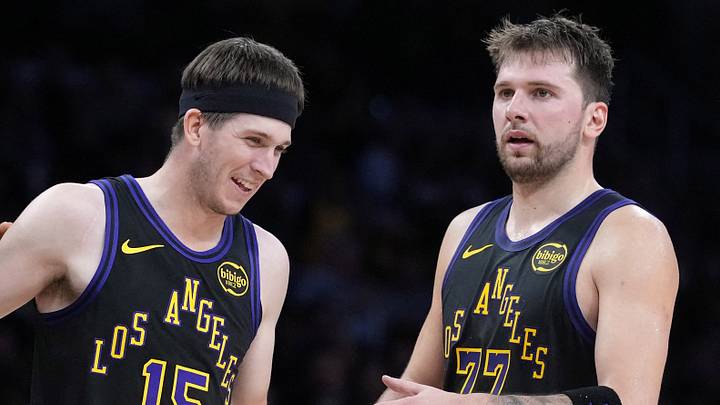 Nov 18, 2025; Los Angeles, California, USA; Los Angeles Lakers guard Austin Reaves (15) is congratulated by forward LeBron James (23) and guard Luka Doncic (77) after a three-point basket in the second quarter at Crypto.com Arena. Mandatory Credit: Kirby Lee-Imagn Images