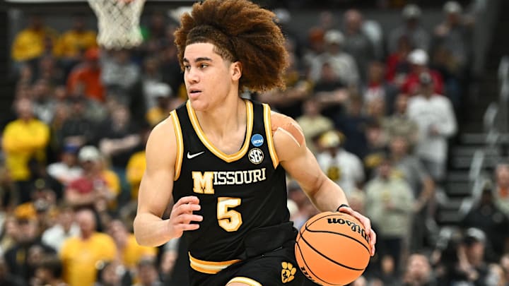 Mar 20, 2026; St. Louis, MO, USA; Missouri Tigers guard T.O. Barrett (5) drives to the basket against Miami (FL) Hurricanes during a first round game of the men's 2026 NCAA Tournament at Enterprise Center. 