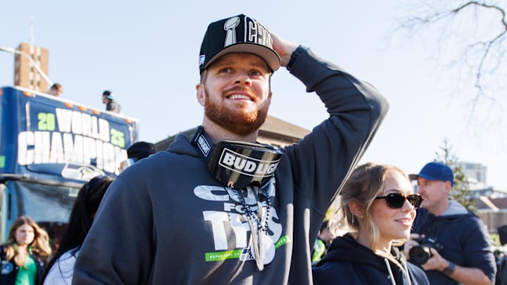 Feb 11, 2026; Seattle, WA, USA;  Seattle Seahawks quarterback Sam Darnold (14) reacts during the Super Bowl LX parade. Mandatory Credit: Kevin Ng-Imagn Images