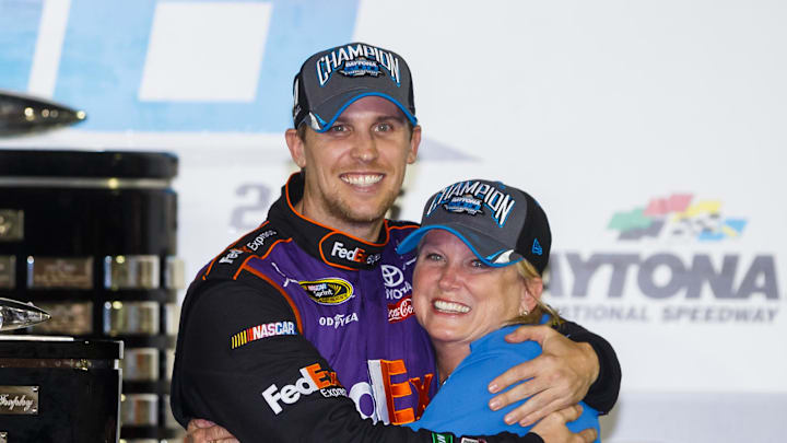 Feb 21, 2016; Daytona Beach, FL, USA; NASCAR Sprint Cup Series driver Denny Hamlin (left) hugs his mother, Mary Lou Hamlin, in victory lane as they celebrate after winning the Daytona 500 at Daytona International Speedway.