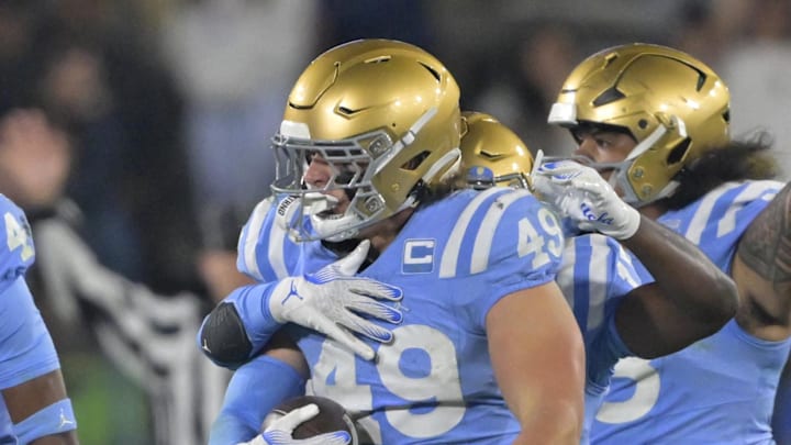 Nov 8, 2024; Pasadena, California, USA;   UCLA Bruins linebacker Carson Schwesinger (49) and teammates celebrate after an interception in the second half against the Iowa Hawkeyes at the Rose Bowl. Mandatory Credit: Jayne Kamin-Oncea-Imagn Images